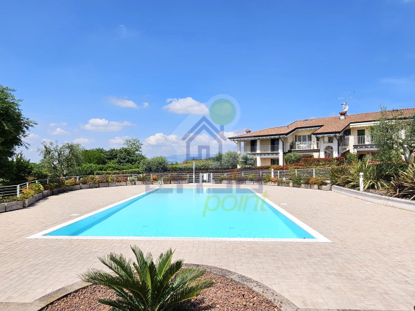 Trilocale con giardino e piscina
